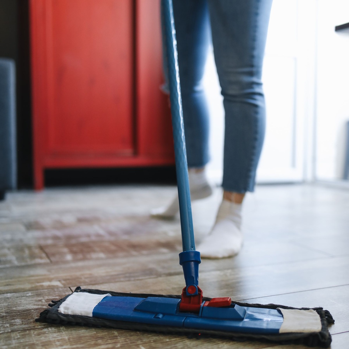 Professional cleaner mopping hard flooring during deep cleaning services near me