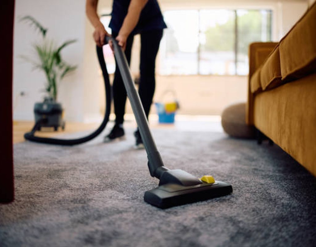 Professional maids thoroughly cleaning a spacious living room in a modern West Jordan, UT home
