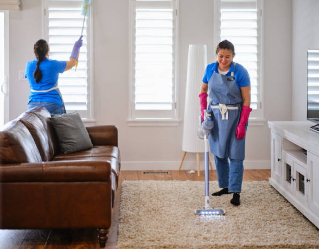 Professional cleaner vacuuming living room in Spanish Fork, UT home